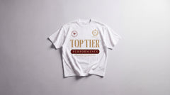 Top Tier Performance Club boxy oversized T-shirt in white, laid flat, gold heritage chest lockup